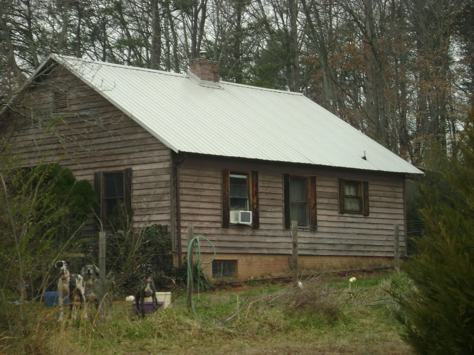 White metal roof on an old wood sided farmhouse, from a Metal Roof Installation job in Summit Hill